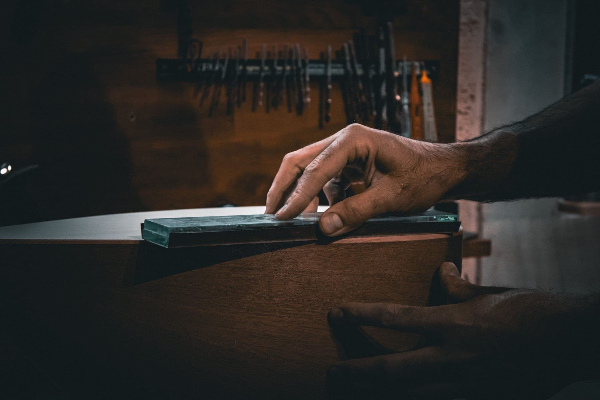 Sharpening stones of different grits stacked on a workbench