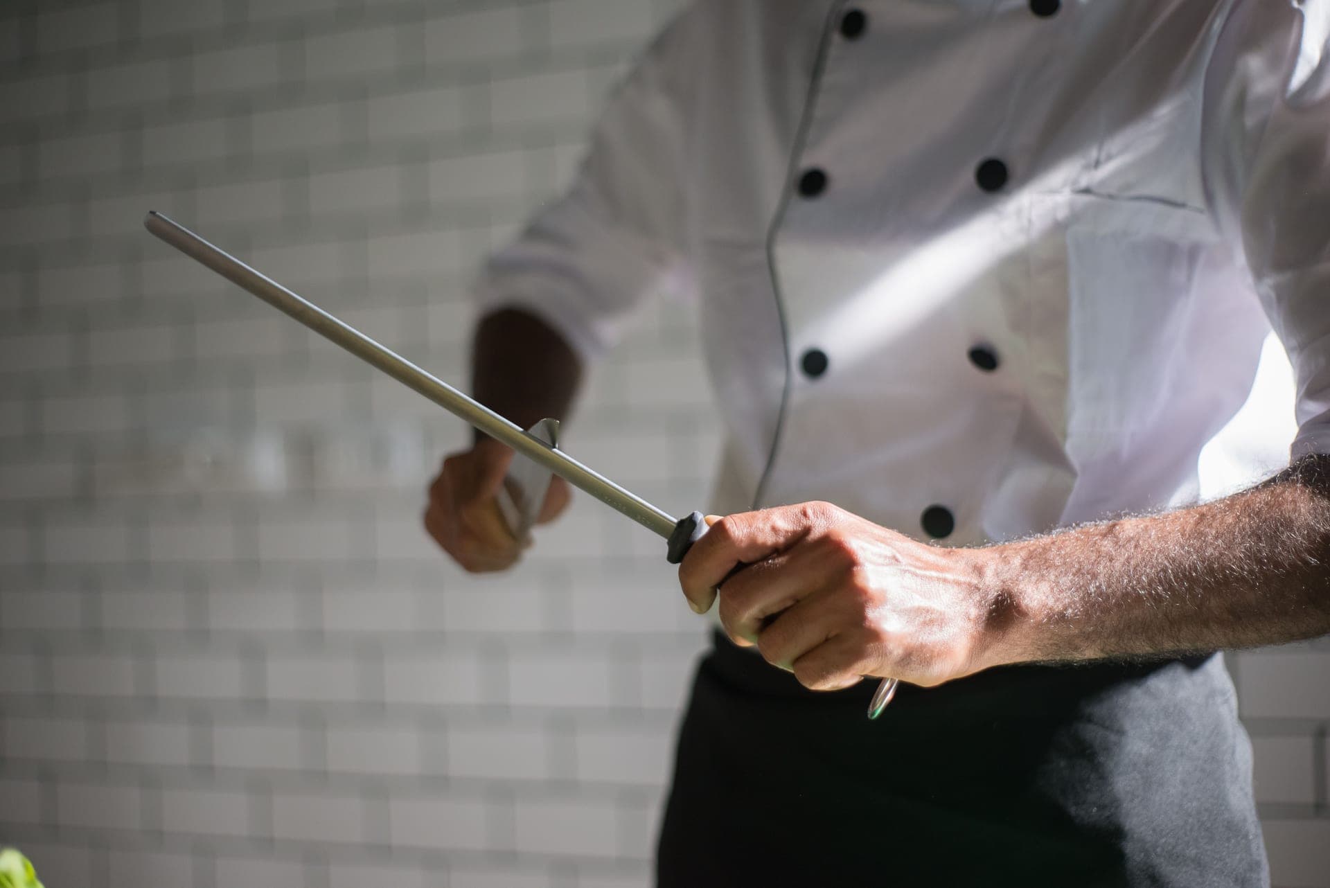 A knife being drawn along a honing steel